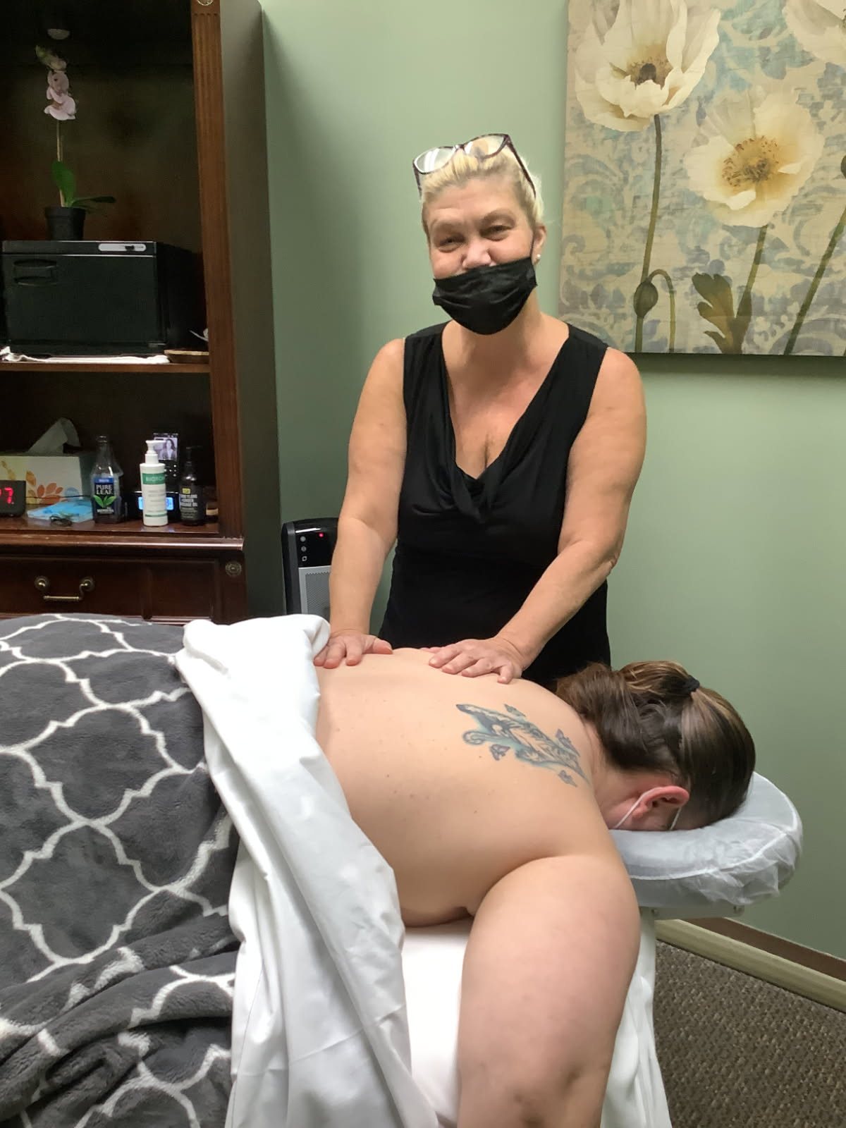 Kara Hayden working on Candi's back during a massage session