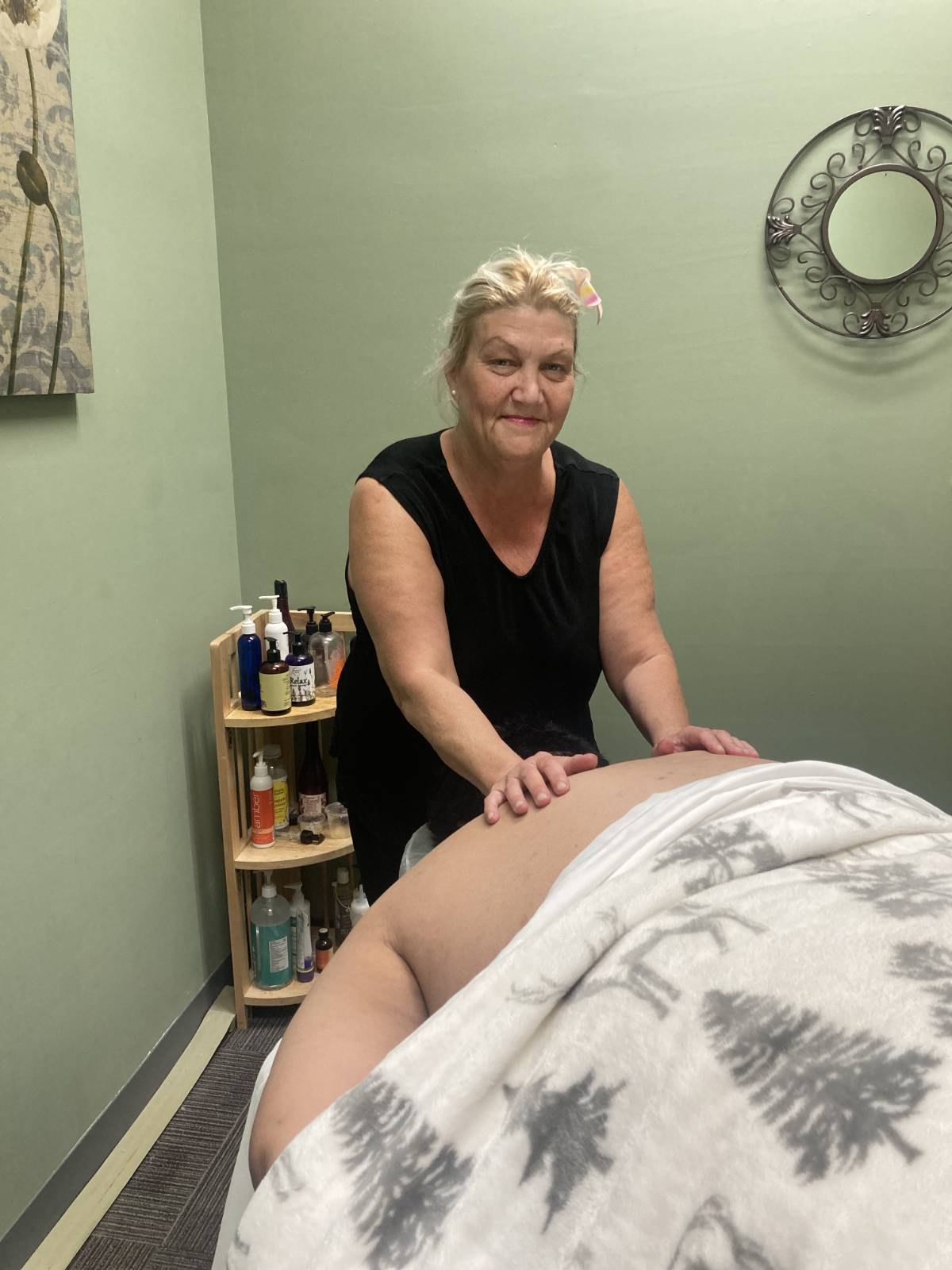 Kara Hayden working on a client's back during a session