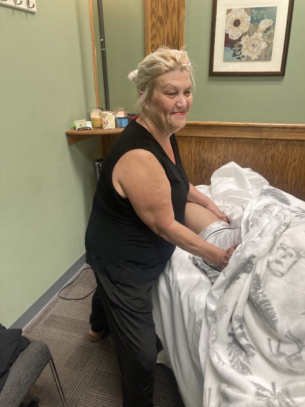 Kara Hayden working on a client's leg during a session