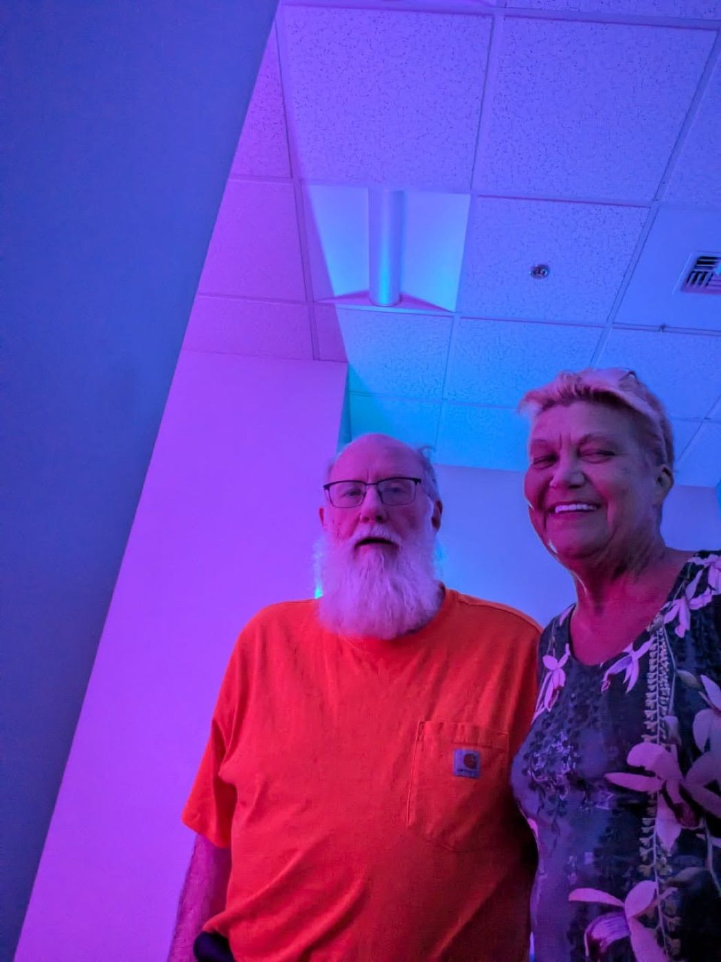 A Veteran patient and his wife smiling in the studio