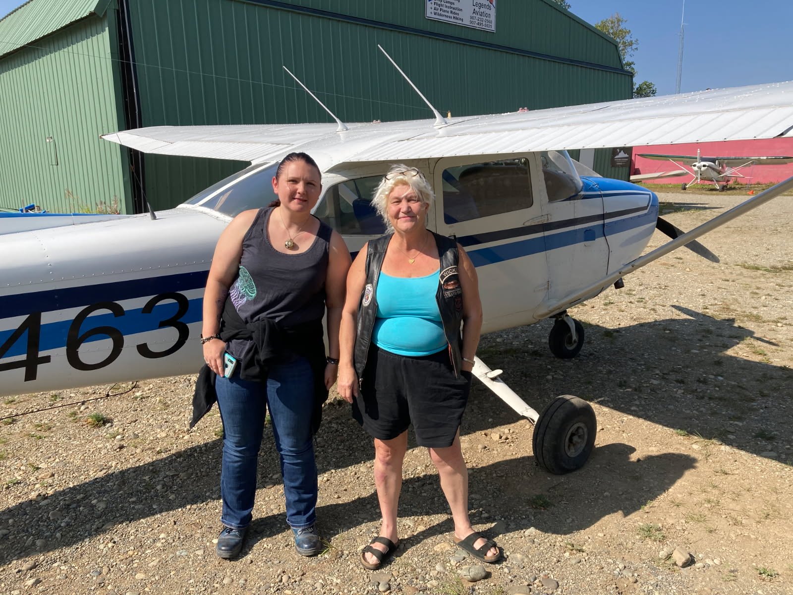 Kara Hayden and Candi beside a small plane on the day of Candi's first flight